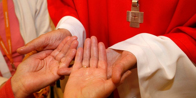 Bishop anointing a sick person (Photo by: Godong/Universal Images Group via Getty Images)