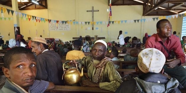 Muslim men take shelter at the Boali church, on January 19, 2014, in Boali, some 100km north of Bangui. Fresh fighting broke out in the strife-torn Central African Republic on the eve of an announcement on Sunday of the candidates seeking to become the new interim president. Sectarian violence has gripped the landlocked country after a March 2013 coup launched by the mostly Muslim Seleka rebels, and the UN has warned that the bloodshed could turn into genocide. AFP PHOTO / ERIC FEFERBERG (Photo credit should read ERIC FEFERBERG/AFP/Getty Images)