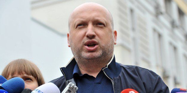 Oleksandr Turchynov, first deputy of Yulia Tymoshenko's party, Batkivschyna and one of the Ukrainian opposition leaders, speaks to journalists after displaying his notice of appointment at Ukraine's Department of the Interior as he was called to the main investigating agency for interrogation in Kiev on May 10, 2012. AFP PHOTO/ SERGEI SUPINSKY (Photo credit should read SERGEI SUPINSKY/AFP/Getty Images)