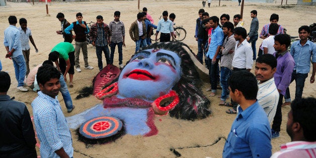 A sand sculpture of Hindu god Lord Shiva, made by Allahabad University students, is pictured on the eve of Maha Shivaratri festival at Sangam in Allahabad on February 26, 2014. Hindus mark the Maha Shivratri festival by offering special prayers and fasting to worship Lord Shiva, the lord of destruction. AFP PHOTO/SANJAY KANOJIA (Photo credit should read Sanjay Kanojia/AFP/Getty Images)