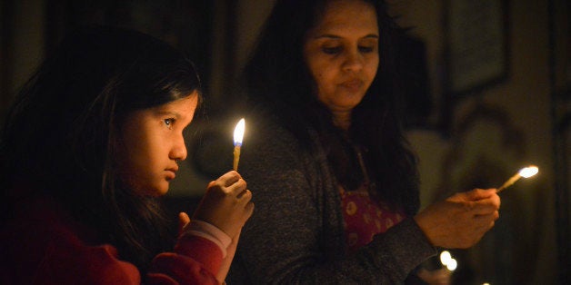 POTOMAC, MD - NOVEMBER 3:
Simran Mattikalli, 7, and her mother Kavitha Mattikalli, of Potomac, MD, offer lights to deities a