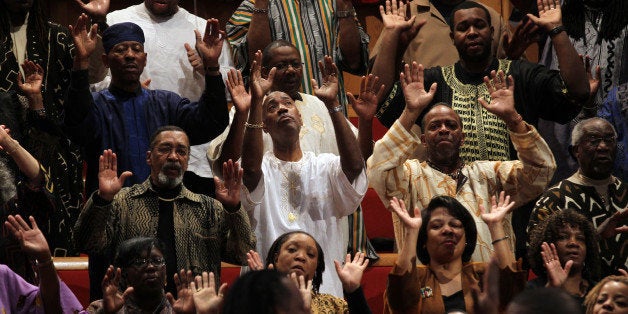 A large choir sings as the Rev. Otis Moss III, senior pastor at Trinity United Church of Christ, leads the service, January 1