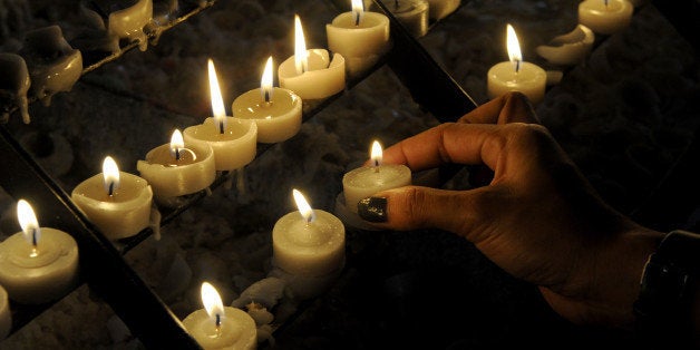 Roman Catholics devotees light candles at a church as the country marks Ash Wednesday, the official beginning of the Christian Lenten season in Manila on February 5, 2014. The ash symbolizes the mortality of human beings, of bodies disintegrating to ash after one dies. The Philippines is Asia's bastion of Catholicism, with over 80 percent of the about 100 million population belonging to the faith. AFP PHOTO / Jay DIRECTO (Photo credit should read JAY DIRECTO/AFP/Getty Images)