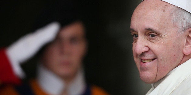 VATICAN CITY, VATICAN - FEBRUARY 20: A Swiss Guard salutes as Pope Francis arrives for an Extraordinary Consistory on Februar