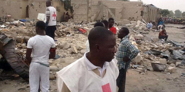 BEST AVAILABLE QUALITY Red Cross officials search on March 2, 2014 for the bodies of the victims and the wounded at the scene where two explosions rocked a crowded neigbourhood in Maiduguri's Gomaris district on the evening of March 1. At least 35 people were killed following two explosions in a crowded neighbourhood of Nigeria's restless northeastern city of Maiduguri, a stronghold of Boko Haram Islamists, police said March 2. 'We are still counting. So far we have counted 35 bodies. Our men are still working with rescue workers at the scene,' Borno state police commissioner Lawal Tanko said. AFP PHOTO / STRINGER (Photo credit should read STRINGER/AFP/Getty Images)