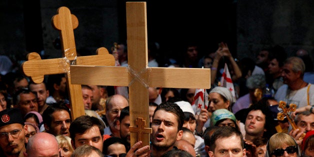 Christian Orthodox pilgrims carry wooden crosses along the Via Dolorosa during a procession marking the Orthodox Good Friday on May 3, 2013 in Jerusalem's old city. Thousands of Christian pilgrims take part in processions along the route where, according to tradition, Jesus Christ carried the cross during his last days. AFP PHOTO/GALI TIBBON (Photo credit should read GALI TIBBON/AFP/Getty Images)