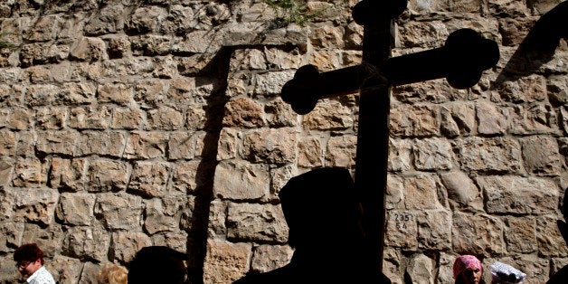 Christian Orthodox pilgrims carry wooden crosses along the Via Dolorosa during a procession marking the Orthodox Good Friday on May 3, 2013 in Jerusalem's old city. Thousands of Christian pilgrims take part in processions along the route where, according to tradition, Jesus Christ carried the cross during his last days. AFP PHOTO/GALI TIBBON (Photo credit should read GALI TIBBON/AFP/Getty Images)