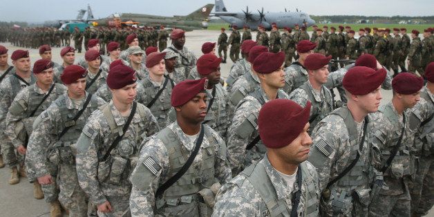 SWIDWIN, POLAND - APRIL 23: Members of the U.S. Army 173rd Airborne Brigade march past a Polish paratrooper unit after a ceremony upon the U.S. troops' arrival by plane at a Polish air force base on April 23, 2014 in Swidwin, Poland. Approximately 150 U.S. troops, as well as another 450 destined for the three Baltic states in coming days, will participate in bilateral military exercises over the coming weeks in a sign of commitment among NATO members. Tensions are rising in eastern Ukraine between Russian separatists and Ukrainian authorities and NATO is seeking to reassure its own members located close to Russia. (Photo by Sean Gallup/Getty Images)