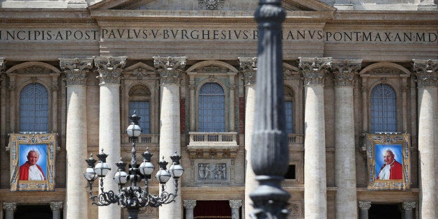 VATICAN CITY, VATICAN - APRIL 25: Tapestries depicting the late Pope John Paul II and Pope John XXIII hang on the balcony of St Peters basilica on April 25, 2014 in Vatican City, Vatican. The late Pope John Paul II and Pope John XXIII will be canonised on Sunday 27 April, inside the Vatican when 800,000 pilgrims from around the world are expected to attend. (Photo by Dan Kitwood/Getty Images)