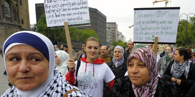 Members of various leftist groups and unions as well as anti-racist groups protest during a demonstration against anti-muslim racism on October 3, 2009 in Berlin. Simultaneously, several supporters of the citizens' movement 'Pax Europe' protest against the Islamisation of Germany and Europe. AFP PHOTO DDP /THEO HEIMANN GERMANY OUT (Photo credit should read THEO HEIMANN/AFP/Getty Images)