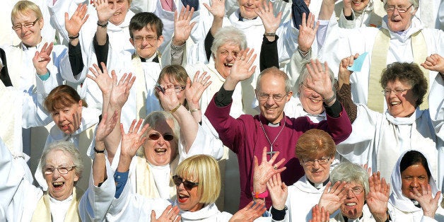 LONDON, ENGLAND - MAY 03: A crowd of hundreds of women priests stand on the steps of St Paul's Cathedral with the Archbishop