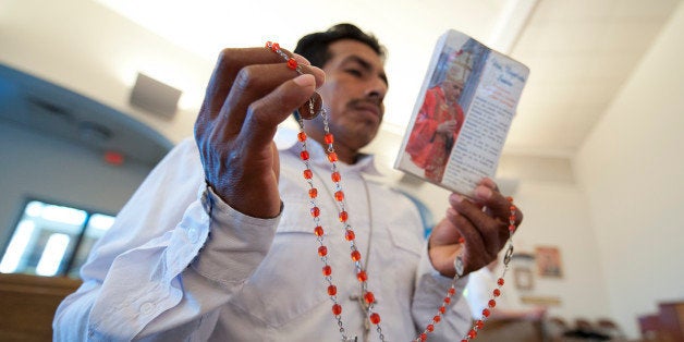UNITED STATES - August 25: Delfino Velazquez holds his rosary beads as he prays with about 200 people who gathered for an emo