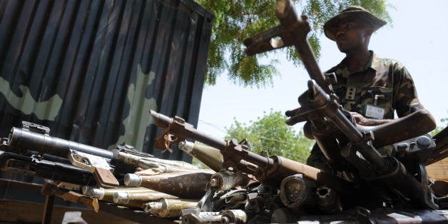 Sector Commander of Multinational Joint Task Force Captain Godwin Akuve displays on April 30, 2013 arms and ammunitions recovered from Islamist insurgent during a clash with soldiers in the remote northeast town of Baga, Borno State. Fierce fighting between Nigerian troops and suspected Islamist insurgents, Boko Haram at Baga town in the restive northeastern Nigeria, on April 25, 2013 left dozens of people dead and scores of civilians injured. But the military denied the casualty figures claiming it was exaggerated to smear its image. Meanwhile normalcy has return to the town as residents are going about their normal business. AFP PHOTO/PIUS UTOMI EKPEI (Photo credit should read PIUS UTOMI EKPEI/AFP/Getty Images)