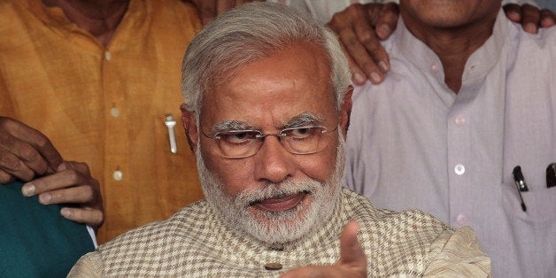 AHMEDABAD, INDIA - MAY 16: Gujarat Chief Minister and Prime Minister Candidate Narendra Modi at Party headquarters after winning a thumping majority in Lok Sabha polls at Dharnidhar on May 16, 2014 in Ahmedabad, India. Recording its best ever performance in its 34-year existence, the BJP led by Narendra Modi on its own was leading in 283 seats, eleven more than the required half-way mark in the 543-member House, while its allies were ahead in 49 seats. (Photo by Vijayanand Gupta/Hindustan Times via Getty Images)