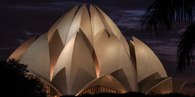 DELHI, INDIA - 2013/09/20: The Bahai Lotus Temple in Delhi is famous for its lotus shape, thus its name. The building is surrounded by 27 marble petals around its circumference. The lotus is a suitable symbol for the Bahai faith as the flower figures prominently in Buddhist, Zoroastrian and Hindu faiths. One of the most visited buildings in the world, an average of 9000 people visit the Bahai House of Worship each day.. (Photo by John S Lander/LightRocket via Getty Images)