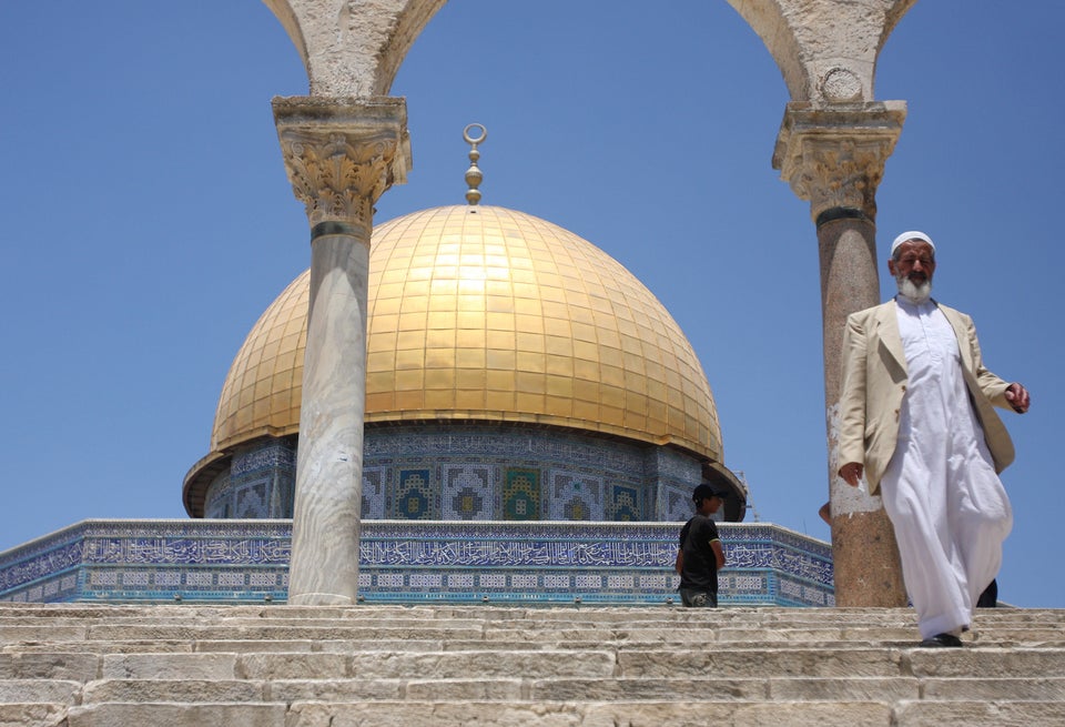 Muslim worshippers walk in front of the Dome of the Rock Mosque in Jerusalem during celebrations marking the Muslim holiday '