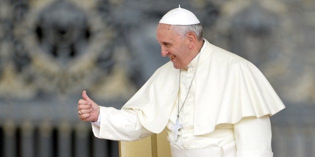 Pope Francis greets the crowd as he arrives for his general audience at St Peter's Square on May 28, 2014 at the Vatican. AF