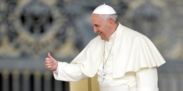 Pope Francis greets the crowd as he arrives for his general audience at St Peter's Square on May 28, 2014 at the Vatican. AFP PHOTO / ANDREAS SOLARO (Photo credit should read ANDREAS SOLARO/AFP/Getty Images)