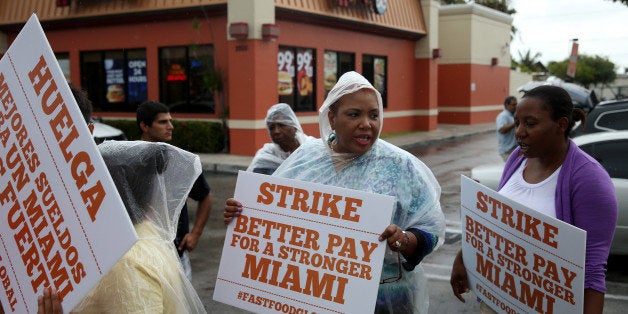 MIAMI, FL - MAY 15: People join in a fast food workers protest in front of a Wendy's restaurant on May 15, 2014 in Miami, Florida. The protesters were part of a nation wide movement to show support for fast food workers wages of $15 an hour and what they say is a need for better working conditions. (Photo by Joe Raedle/Getty Images)