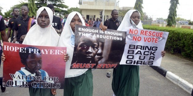 School pupils hold signs as members of Lagos based civil society groups hold rally calling for the release of missing Chibok school girls at the state government house, in Lagos, Nigeria, on May 5, 2014. Boko Haram on Monday claimed the abduction of hundreds of schoolgirls in northern Nigeria that has triggered international outrage, threatening to sell them as 'slaves'. 'I abducted your girls,' the Islamist group's leader Abubakar Shekau said in the 57-minute video obtained by AFP, referring to the 276 students kidnapped from their boarding school in Chibok, Borno state, three weeks ago. AFP PHOTO / PIUS UTOMI EKPEI (Photo credit should read PIUS UTOMI EKPEI/AFP/Getty Images)