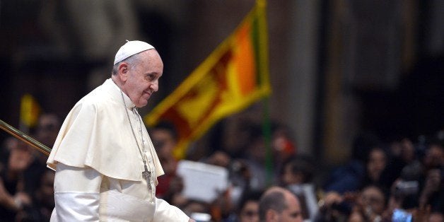 Pope Francis leaves after a meeting with the Sri Lankan community and a mass held by the Archbishop of Colombo at St Peter's Basilica on February 8, 2014 at the Vatican. AFP PHOTO / GABRIEL BOUYS (Photo credit should read GABRIEL BOUYS/AFP/Getty Images)