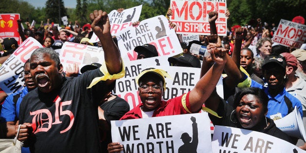 OAK BROOK, IL - MAY 21: Fast food workers and activists demonstrate outside the McDonald's corporate campus on May 21, 2014 in Oak Brook, Illinois. The demonstrators were calling on McDonald's to pay a minimum wage of $15-per-hour and offer better working conditions for their employees. Several protestors were arrested after they entered and ignored police orders to leave the McDonald's campus. McDonald's is scheduled to hold its annual shareholder's meeting tomorrow at the campus. (Photo by Scott Olson/Getty Images)