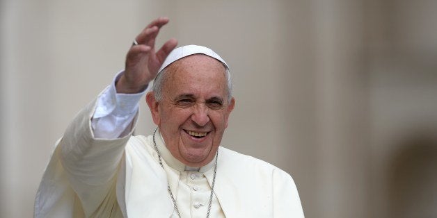 Pope Francis greets the crowd as he arrives for his general audience at St Peter's square on June 25, 2014 at the Vatican. AFP PHOTO / FILIPPO MONTEFORTE (Photo credit should read FILIPPO MONTEFORTE/AFP/Getty Images)