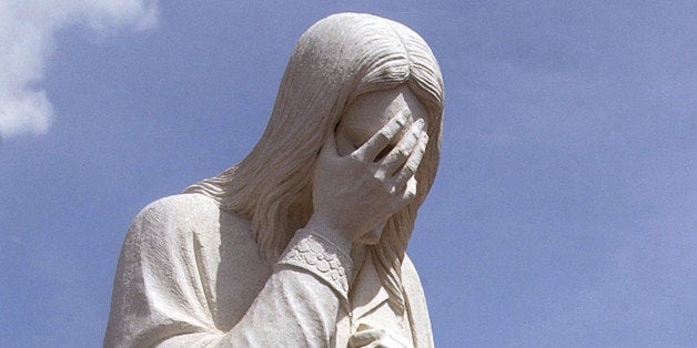 OKLAHOMA CITY, OK - APRIL 13: Peace activists walk past the 'And Jesus Wept' statue on the west side of the Oklahoma City National Memorial as they participate in the 'Spiritual Walk for Peace' march April 13, 2003 in Oklahoma City, Oklahoma. The Spiritual Walk for Peace event takes place each Sunday. Those who participate silently walk around the Alfred P. Murrah Federal Building memorial site in downtown Oklahoma City while holding signs to protest against military action in Iraq. (Photo by Mark Zimmerman/Getty Images)