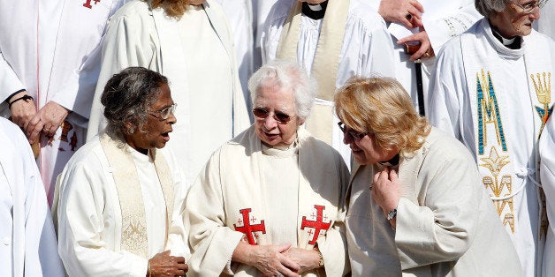 LONDON, ENGLAND - MAY 03: A group of women priests stand among hundreds on the steps of St Paul's Cathedral before going ins