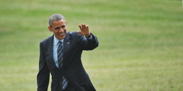 US President Barack Obama makes his way across the South Lawn upon return to the White House on July 10, 2014 in Washington,