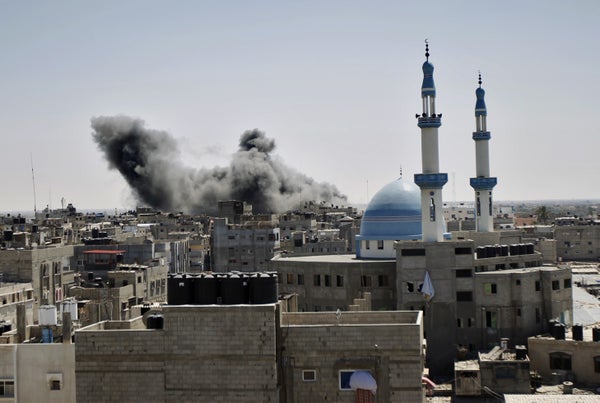 Smoke billows from a building hit by an Israeli air strike in the town of Rafah, in the southern Gaza Strip, on July 14, 2014