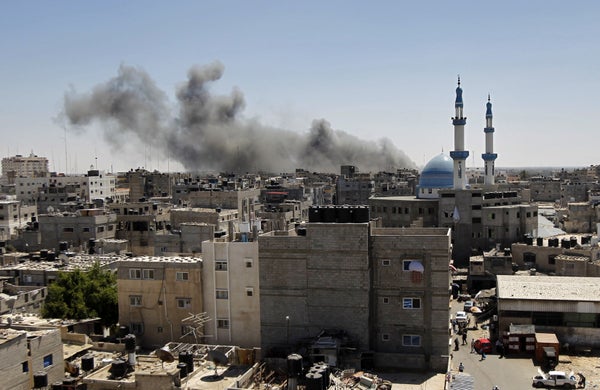 Smoke billows from a building hit by an Israeli air strike in the town of Rafah, in the southern Gaza Strip, on July 14, 2014