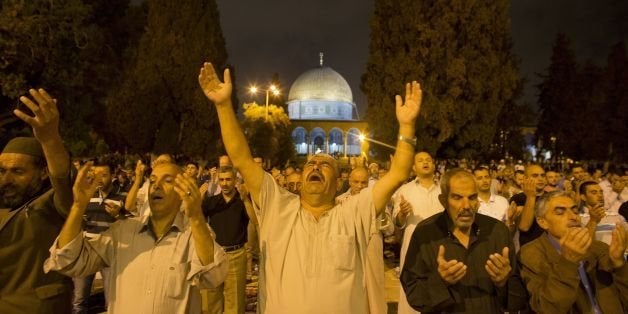 Palestinians hold night prayers in front of the Dome of the Rock at the Al-Aqsa Mosque compound in the Old City of Jerusalem in support of Palestinians in Gaza July 20, 2014, during Israel's military operation in the Gaza Strip. AFP PHOTO / AHMAD GHARABLI (Photo credit should read AHMAD GHARABLI/AFP/Getty Images)