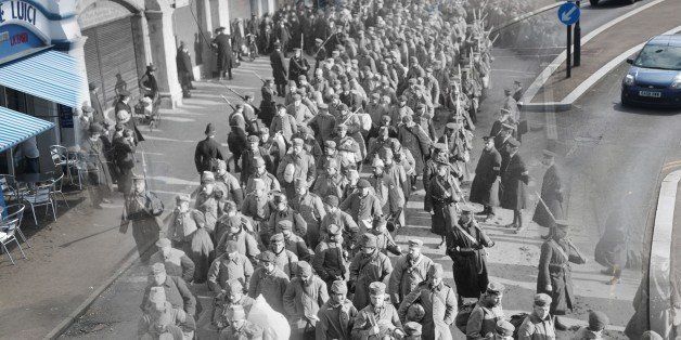 In this digital composite image a comparison has been made of Southend on Sea during World War I (Archive, Topical Press Agency) and Modern Day 2014 by Photographer Peter Macdiarmid. *** WWI ARCHIVE *** SOUTHEND ON SEAS, ENGLAND - 1914: German prisoners of war during the First World War on their way to Southend Pier accompanied by guards and watched by the local populace (Photo by Topical Press Agency/Getty Images) ***MODERN DAY*** LONDON, UNITED KINGDOM - JULY 17: Sunshine on the seafront on July 17, 2014 in Southend on Sea, England. Throughout 2014 the First World War's Centenary will be remembered. (Photo by Peter Macdiarmid/Getty Images)