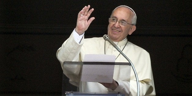 Pope Francis gestures as he delivers a speech from the window of his apartment during his Sunday Angelus prayer in St. Peter'