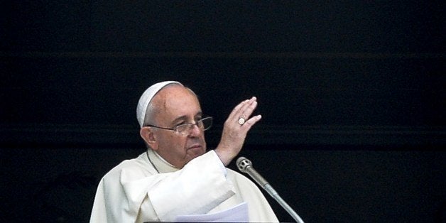 Pope Francis gestures as he delivers a speech from the window of his apartment during his Sunday Angelus prayer in St. Peter'