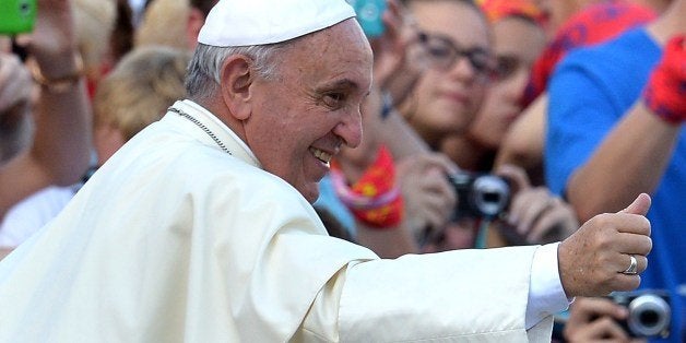 Pope Francis meets with German altar servers during an open-air meeting in Saint Peter's Square at the Vatican on August 5, 2014. AFP PHOTO / ALBERTO PIZZOLI (Photo credit should read ALBERTO PIZZOLI/AFP/Getty Images)