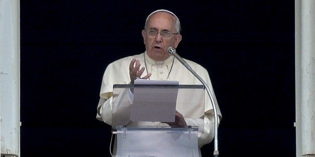Pope Francis delivers a speech from the window of his apartment during his Sunday Angelus prayer in St. Peter's Square at the