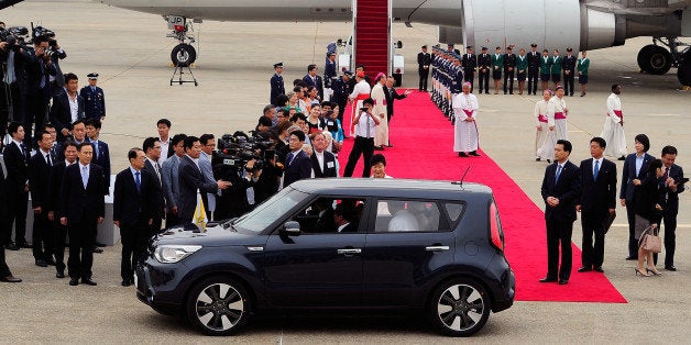 SEOUL, SOUTH KOREA - AUGUST 14: Pope Francis (inside a car) arrives at Seoul military airport on August 14, 2014 in Seoul, South Korea. Pope Francis is visiting South Korea from August 14 to August 18. This trip is the third trip abroad for the pope following Brazil and the Middle East. This is the third pontifical visit to South Korea. (Photo by Song Kyung-Seok-Pool/Getty Images)