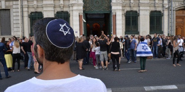 A man wearing a skullcap looks on as people take part in a demonstration called by the Representative Council of Jewish Institutions in France (CRIF) on July 31, 2014 in front of Lyon's synagogue, as France is considering disbanding a radical Jewish group, the Jewish Defence League (LDJ), whose members clashed with pro-Palestinian activists during rallies over Israel's offensive in Gaza. The rally is in response to weeks of pro-Palestinian protests marred by clashes, arrests and allegations of anti-Semitism in which synagogues were targeted and Israeli flags burnt. AFP PHOTO / ROMAIN LAFABREGUE (Photo credit should read ROMAIN LAFABREGUE/AFP/Getty Images)