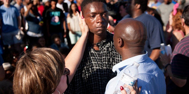 FERGUSON, MISSOURI - August 13, 2014: The Rev. Willis Johnson (right) confronts 18-year-old Joshua Wilson as protesters defy police and block traffic on West Florissant Avenue at Canfield Drive in Ferguson, Mo. Wednesday, Aug. 13, 2014 as part of their protests over the the shooting of 18-year-old Michael Brown, Jr., who died Saturday, Aug. 9, 2014 following an altercation with police in the St. Louis suburb. Rev. Johnson convinced Wilson, one of the last holdouts in the intersection, that he should leave and avoid arrest. Joining Johnson and Wilson was a member of the clergy from the African Episcopal Methodist Church who declined to give her name. (Photo by Sid Hastings/For The Washington Post via Getty Images)