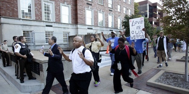 A group of pastors, clergy and protesters march to the office building of St. Louis County Prosecutor Bob McCullough on August 20, 2014 in Clayton, Missouri, demanding justice in the police shooting of Michael Brown. McCullough has not filed any charges against Ferguson Police Officer Darren Wilson, after Wilson fatally wounded Brown August 9th. AFP PHOTO/Joshua LOTT (Photo credit should read Joshua LOTT/AFP/Getty Images)