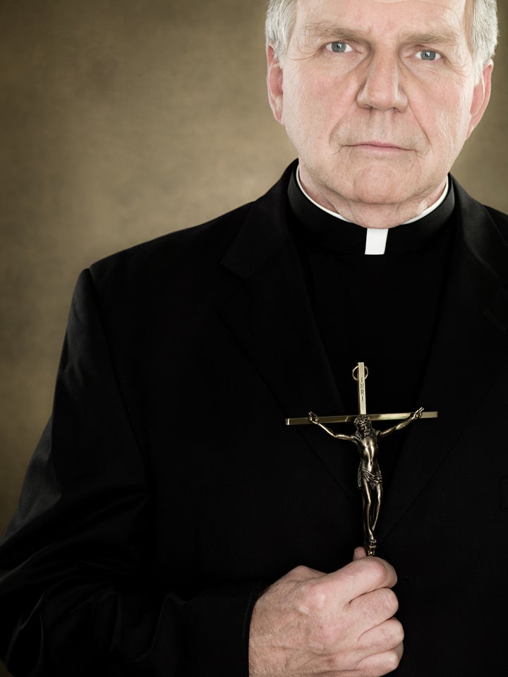 A priest holding a crucifix