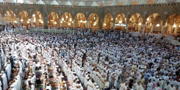 MECCA, SAUDI ARABIA - JULY 24: Muslims perform prayer at the Masjid al-Haram, the largest and oldest mosque surrounding Islam's holiest place, the Kaaba, during the Laylat al-Qadr in the holy month Ramadan in Mecca, Saudi Arabia on July 24, 2014. (Photo by Halis Akyildiz/Anadolu Agency/Getty Images)