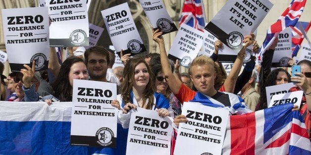 People hold placards and Israeli and Union flags outide the Royal Courts of Justice as Jewish groups rally in London on August 31, 2014, calling for 'Zero Tolerance for Anti-Semitism'. Jewish groups demonstrated outside the British High Court as latest figures published by the Community Security Trust reported a spike in anti-semitic attacks on people and property in the UK following the lastest outbreak of violence between Israel and Palestinians in Gaza. AFP PHOTO / JUSTIN TALLIS (Photo credit should read JUSTIN TALLIS/AFP/Getty Images)