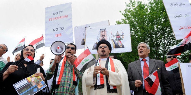 Imam Hamed Mazloum, center, and other rally outside the White House in Washington, Saturday, June 21, 2014, protesting against terrorism and the other against the al Qaida splinter group, the Islamic State of Iraq and the Levant, ISIL (sometimes called ISIS). Two groups protested in front of the White House at the same time Saturday; the other group demonstrated against any further U.S. involvement in Iraq. (AP Photo/Susan Walsh)