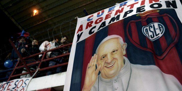 A banner with the image of Pope Francis hangs from a stand of Pedro Bidegain stadium in Buenos Aires, Argentina, on August 13, 2014 during the Copa Libertadores 2014 second leg football final between Argentina's San Lorenzo and Paraguay's Nacional. AFP PHOTO / Juan Mabromata (Photo credit should read JUAN MABROMATA/AFP/Getty Images)