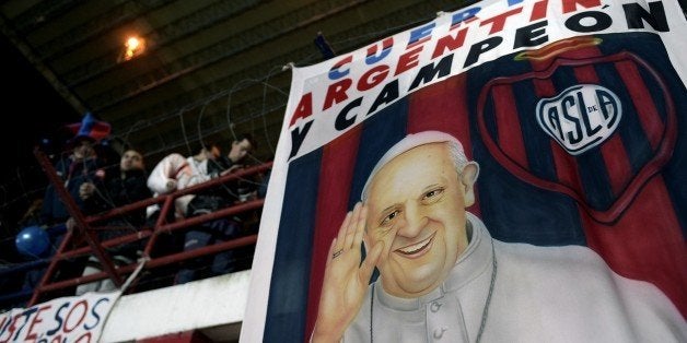 A banner with the image of Pope Francis hangs from a stand of Pedro Bidegain stadium in Buenos Aires, Argentina, on August 1