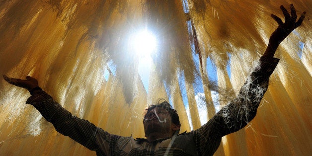 An Indian worker dries vermicelli, used to make a traditional sweet dish popular during the fasting month of Ramadan, in Allahabad on July 17, 2013. Islam's holy month of Ramadan is calculated on the sighting of the new moon and Muslims all over the world are supposed to fast from dawn to dusk during the month. AFP PHOTO/ SANJAY KANOJIA (Photo credit should read Sanjay Kanojia/AFP/Getty Images)