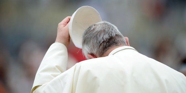 Pope Francis takes off his skullcap during his weekly general audience in St Peter's Square at the Vatican on September 10, 2014. AFP PHOTO / FILIPPO MONTEFORTE (Photo credit should read FILIPPO MONTEFORTE/AFP/Getty Images)